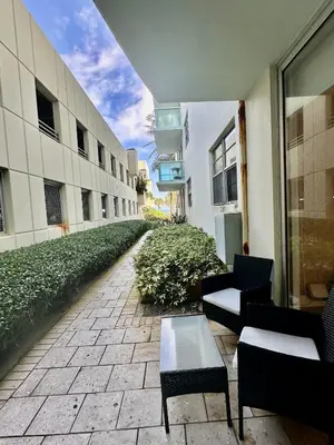 an empty courtyard of a building with chairs and a table at Amazing beachfront condo at Tides on Hollywood Beach Luxury Resort in Hollywood