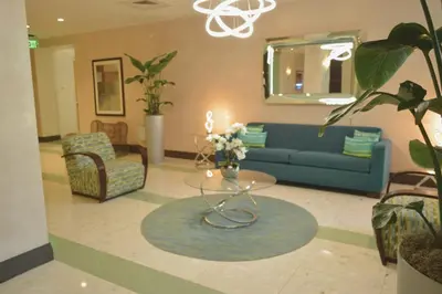 a living room with a blue couch and a table at Amazing beachfront condo at Tides on Hollywood Beach Luxury Resort in Hollywood
