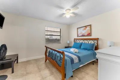 a bedroom with a bed and a ceiling fan at Spacious 5BR Home with Pool, Near Downtown & Beach in Hollywood
