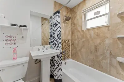 a bathroom with a sink and a toilet and a shower at Spacious 5BR Home with Pool, Near Downtown & Beach in Hollywood