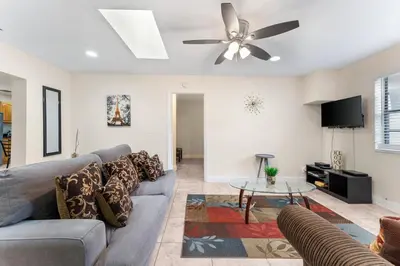 a living room with a couch and a ceiling fan at Spacious 5BR Home with Pool, Near Downtown & Beach in Hollywood