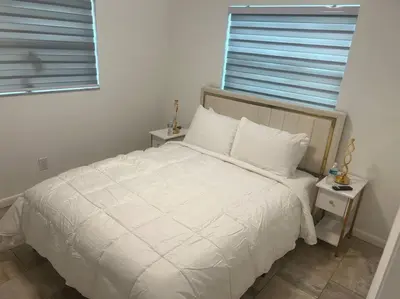 a bedroom with a white bed and a window at Hollywood Golden House Modern & luxurious Studio in Hollywood