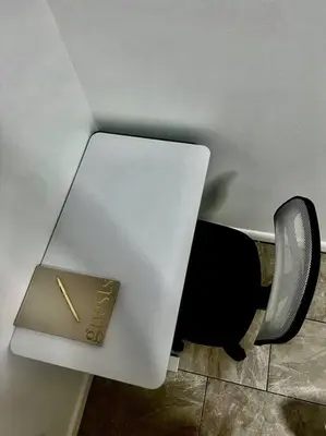 a white table with a book on it next to a chair at Hollywood Golden House Modern & luxurious Studio in Hollywood