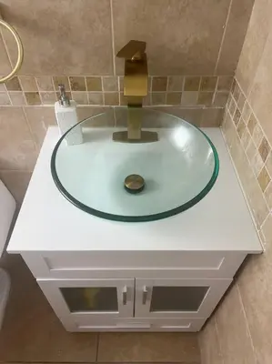 a sink in a bathroom with a glass counter top at Hollywood Golden House Modern & luxurious Studio in Hollywood