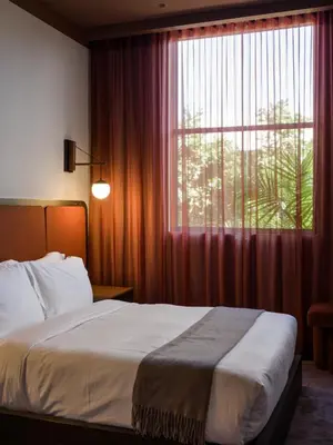 a bedroom with a bed and a large window at The Rover Miami in Miami