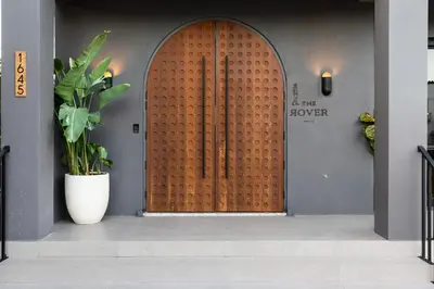 a wooden door in a building with a plant at The Rover Miami in Miami