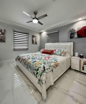 a bedroom with a bed and a ceiling fan at Flamingo Paradise in Hialeah