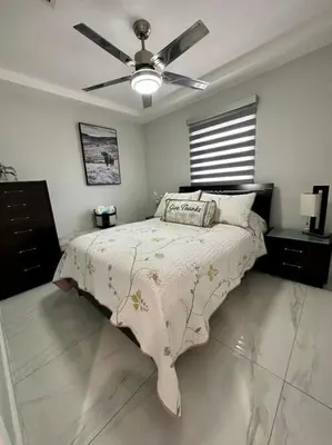 a bedroom with a bed and a ceiling fan at Flamingo Paradise in Hialeah