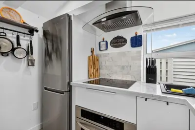 a kitchen with a refrigerator and a stove at Fort Lauderdale airport and Dania Pointe shopping 5 min away in Fort Lauderdale