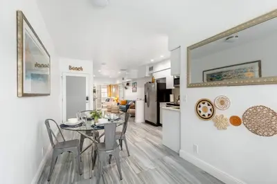 a dining room and kitchen with a table and chairs at Ocean Views! Steps from Dining, Shopping, Las Olas in Fort Lauderdale