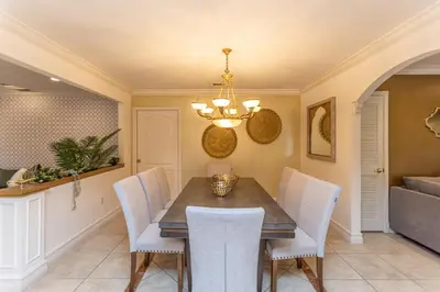 a dining room with a table and white chairs at Miami House - Heated Pool - Family Vacation in Miami