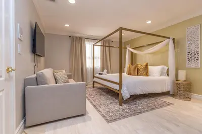 a bedroom with a canopy bed and a couch at Miami House - Heated Pool - Family Vacation in Miami