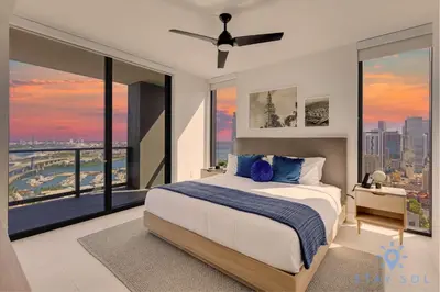 a bedroom with a large bed and large windows at Apartment 3BR-3 BTH - Gym & Pool in Miami
