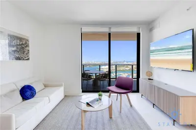 a living room with a white couch and a table at Apartment 3BR-3 BTH - Gym & Pool in Miami