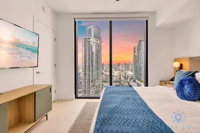 a bedroom with a bed and a large window at Modern 1BR Apartment with Pool in Miami