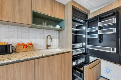 a kitchen with a sink and a refrigerator at Modern 1BR Apartment with Pool in Miami