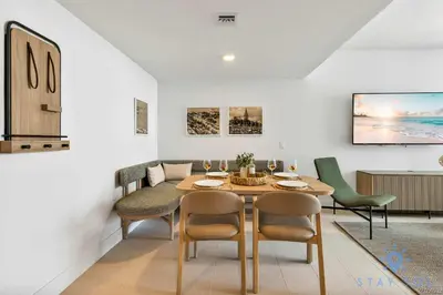 a dining room with a table and chairs at Modern 1BR Apartment with Pool in Miami