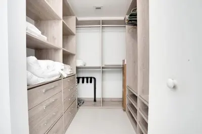 a bedroom with wooden shelves and a bed at Miami Paraiso- Rooftop pool views and prime location in Miami