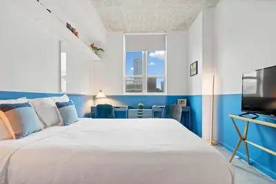 a bedroom with a large bed and a tv at City Loft - Downtown Bayfront pool gym & parking in Miami