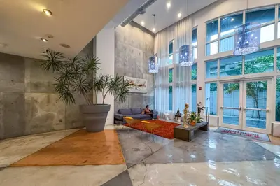 a large living room with a couch and a table at City Loft - Downtown Bayfront pool gym & parking in Miami