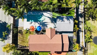an overhead view of a house and a swimming pool at Heated Pool Tropical House with Summer Kitchen 3BR- Oasis in Miami! in Miami