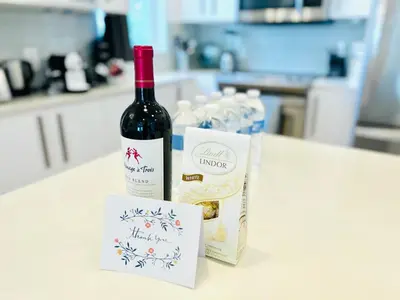a bottle of wine sitting on top of a counter at Heated Pool Tropical House with Summer Kitchen 3BR- Oasis in Miami! in Miami