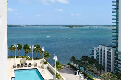 a view of the ocean from the balcony of a building at Amazing Condo Brickell with Ocean-Pool View in Miami