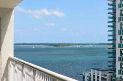 a view of the water from a balcony of a building at Amazing Condo Brickell with Ocean-Pool View in Miami