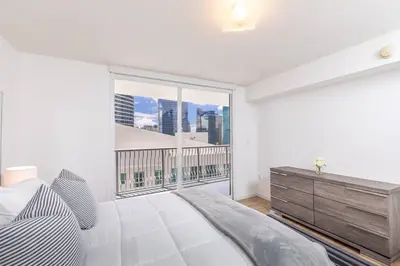 a bedroom with a bed and a large window at Spacious 29th Floor 1 BED 1 BTH Brickell Ocean View in Miami