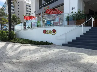 a white building with stairs and a glass railing at 2BR W Residence FLL, OCEAN VIEWS, Infinity pool, hot tub, large balcony, easy amentiy access in Fort Lauderdale