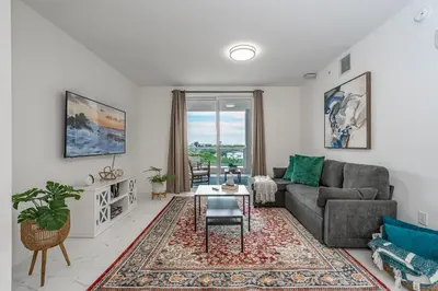a living room with a couch and a table at Stylish Apt with Pool and Gym near beach in Hollywood