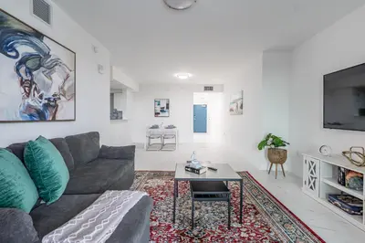 a living room with a couch and a table at Stylish Apt with Pool and Gym near beach in Hollywood