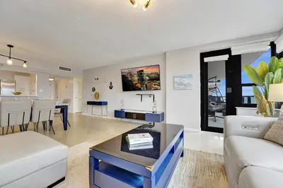 a living room with a couch and a table at Breathtaking 2 Bedroom Condo w Beach Service 919 in Miami Beach