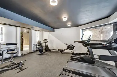 a gym with treadmills and elliptical machines at Cozy Ocean View Condo Beach Service 610 in Miami Beach