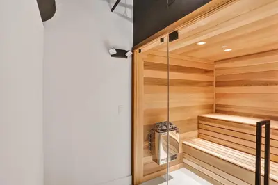 a sauna with wooden walls and a glass door at Luxury Ocean View Condo Resort Amenities 501 in Miami Beach