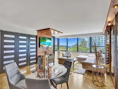 a living room with a glass table and chairs at Luxury Ocean View Condo Resort Amenities 501 in Miami Beach