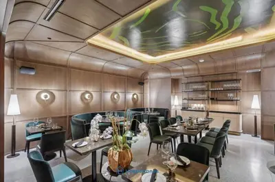 a restaurant with tables and chairs and a ceiling at Apartment in New Luxury Condo in Downtown in Miami