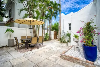 a patio with a table and an umbrella at Casa Roselle # 1 in Hollywood