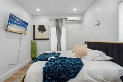 a bedroom with a bed with a blue blanket on it at Casa Roselle # 2 in Hollywood
