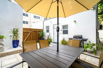 a wooden table with an umbrella on a patio at Casa Roselle # 3 in Hollywood