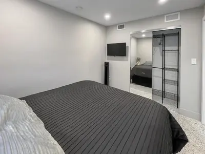 a bedroom with a large bed and a television at Newly Remodeled full Apartment in Miami