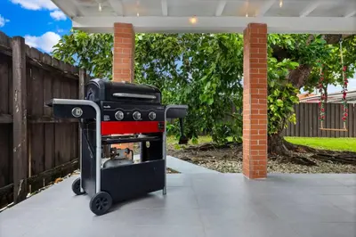 a black and red grill sitting on a patio at La Casita by TilahStays in Miami