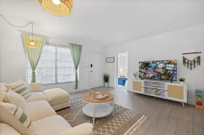 a living room with a couch and a tv at La Casita by TilahStays in Miami