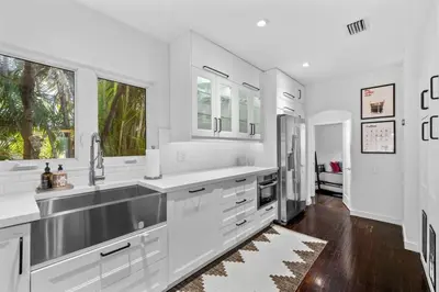a white kitchen with a sink and a refrigerator at Miami Hidden Garden by TilahStays in Miami