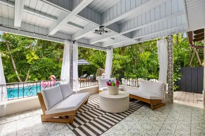 a living room with two chairs and a table at Miami Hidden Garden by TilahStays in Miami