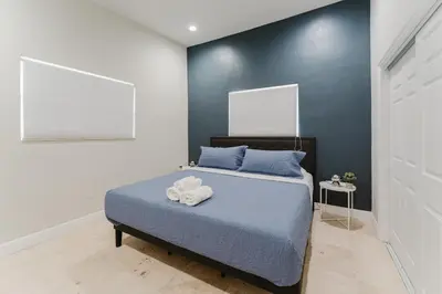a bedroom with a bed with two towels on it at Beautiful Aventura Villa Sleeps 26 in Miami