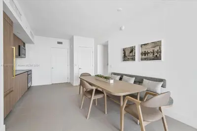 a kitchen and dining room with a table and chairs at Panoramic Ocean View 3 bedroom Nativo Pool Gym SPA in Miami