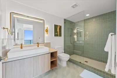 a bathroom with a tub and a toilet and a shower at Panoramic Ocean View 3 bedroom Nativo Pool Gym SPA in Miami
