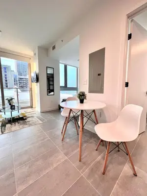 a living room with a white table and chairs at Ocean View Entire Condo In Downtown With Pool and Gym in Miami