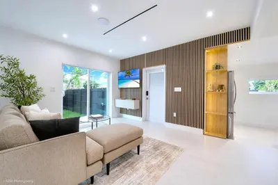 a living room with a couch and a table at The Rock & Rhythm Villa Miami Downtown - Playground,Mini Golf, BBQ, Garden Relaxation in Miami